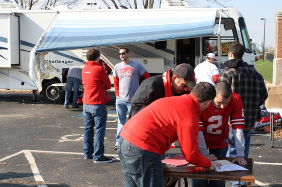 Jason and Ramzy cover security with Danny the intern while Chris and Luke talk logistics in the background