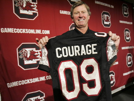 "HERE OL BALL COACH, HOLD THIS HERE PRETENCIOUS JERSEY UP AND POSE WITH IT"