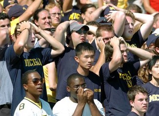 Michigan fans react in shock to something or other.