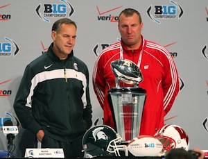 To be fair, Dantonio is sort of smiling in this picture, though it looks to be a painful ordeal for him.
