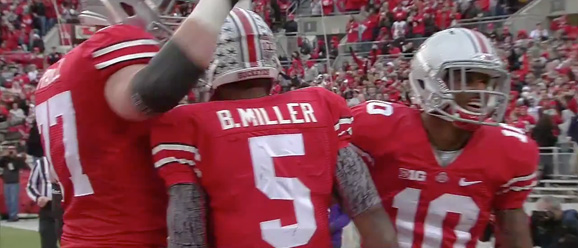Tackle Reid Fragel, quarterback Braxton Miller and receiver Corey Brown hold a group celebration after Miller scored on a two yard touchdown.
