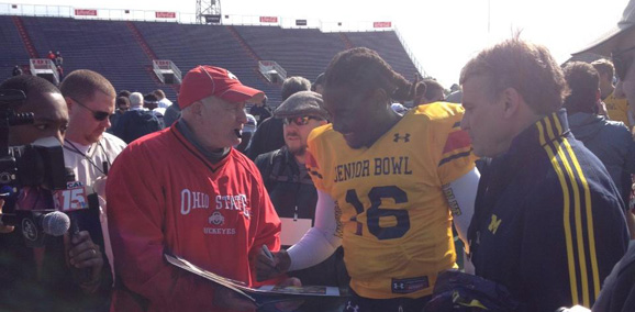 Michigan's Denard Robinson signs something for an Ohio State fan. But what?