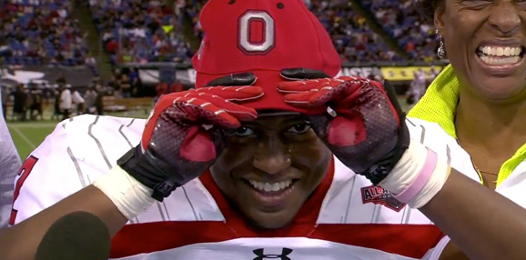 Trey Johnson dons an Ohio State hat, signaling his choice to play football for the Buckeyes