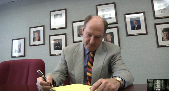 Jim Delany doing paperwork. We see you, Gordon Gee.