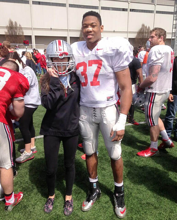 Little sis tries on Josh Perry's helmet