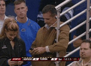 Urban Meyer checking his phone for the latest tweets from @11W