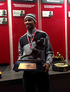 Lonnie Johnson Holds The Heisman Trophy