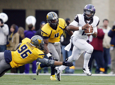 WVU's Korey Harris reaches for a tackle against a TCU player.