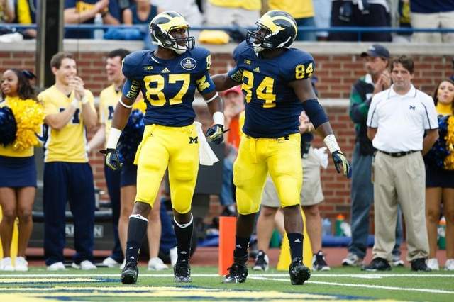 Oct 5, 2013; Ann Arbor, MI, USA; Michigan Wolverines tight end Devin Funchess (87) receives congratulations from tight end A.J. Williams (84) after making a catch against the Minnesota Golden Gophers at Michigan Stadium. / Rick Osentoski-USA TODAY Sports