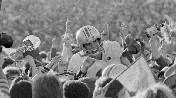 Art Schlichter celebrates with the Buckeye faithful while at least one spectator is soaking in the spirits.