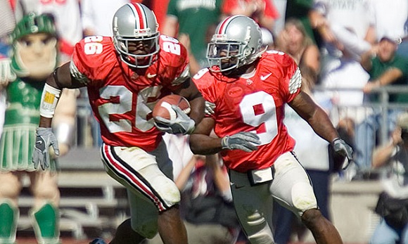 Ashton Youboty (#26) takes a blocked FG to the house escorted by Donte Whitner (#9).