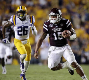 Dak Prescott runs around LSU in 2014.