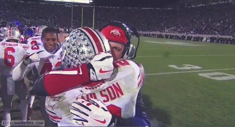 Zach Smith hugs Dontre Wilson after a 4th quarter score.