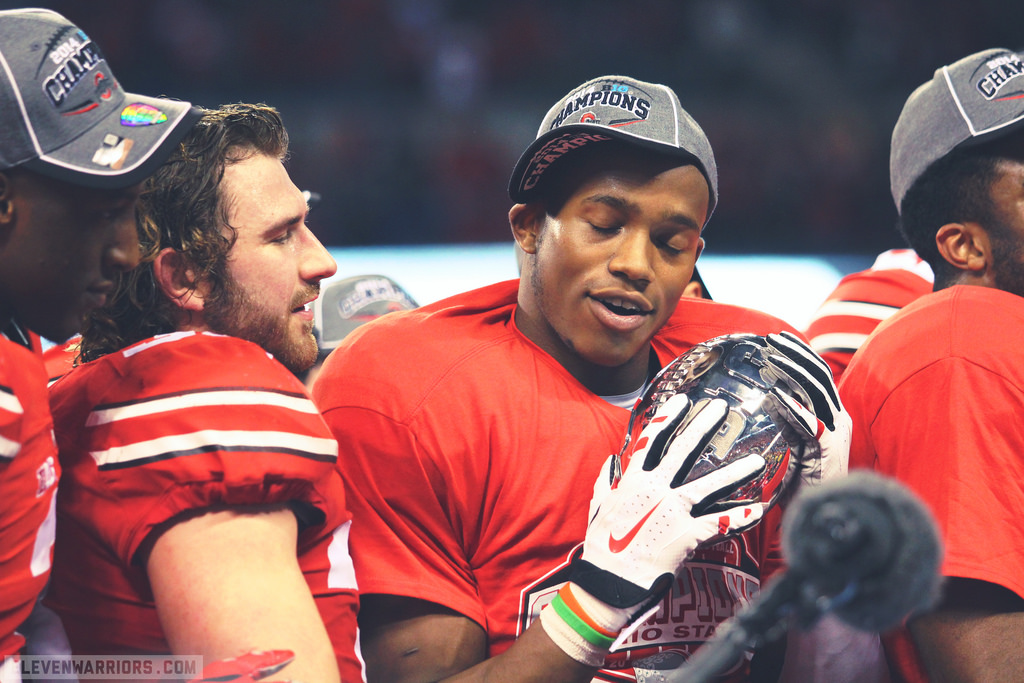 Darron Lee clutches the prize after Ohio State beat Wisconsin 59–0 in the Big Ten Championship