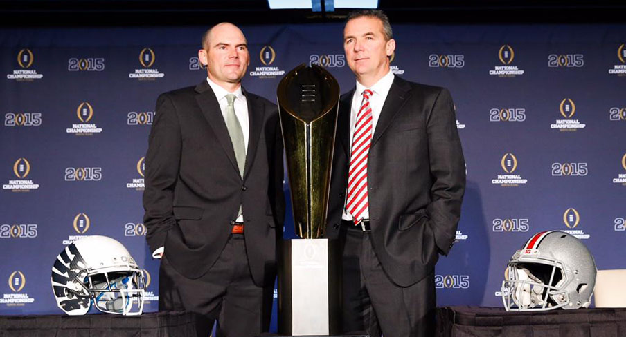 Oregon Ducks coach Mark Helfrich and Ohio State Buckeyes coach Urban Meyer, posing with the National Championship trophy.