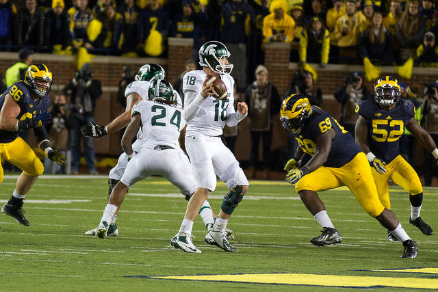 Connor Cook drops back to pass vs. Michigan.