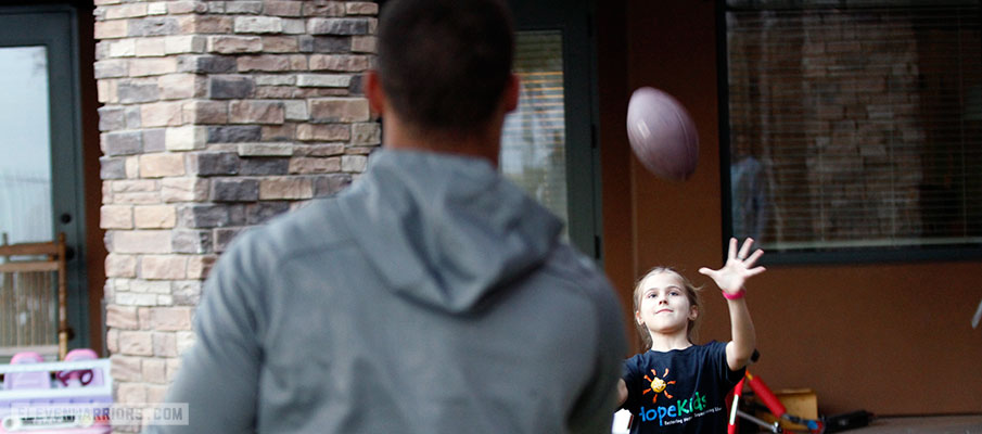 Stephen Collier playing catch with a resident of the Ryan House.