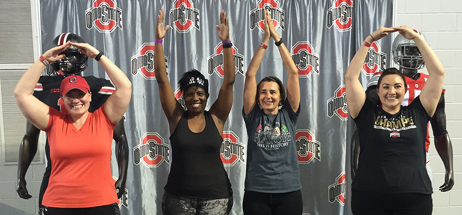 Women form an O-H-I-O at the Ohio State Football Women's Clinic