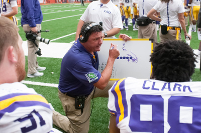 Sep 26, 2015; Syracuse, NY, USA; LSU Tigers defensive line coach Ed Orgeron instructs his players on the bench during the fourth quarter of a game against the Syracuse Orange at the Carrier Dome. LSU won the game 34-24. Mandatory Credit: Mark Konezny-USA TODAY Sport