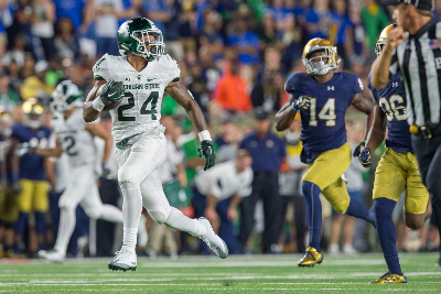 Sep 17, 2016; South Bend, IN, USA; Michigan State Spartans running back Gerald Holmes (24) runs for a touchdown as Notre Dame Fighting Irish safety Devin Studstill (14) pursues in the third quarter at Notre Dame Stadium. MSU won 36-28. Mandatory Credit: Matt Cashore-USA TODAY Sports