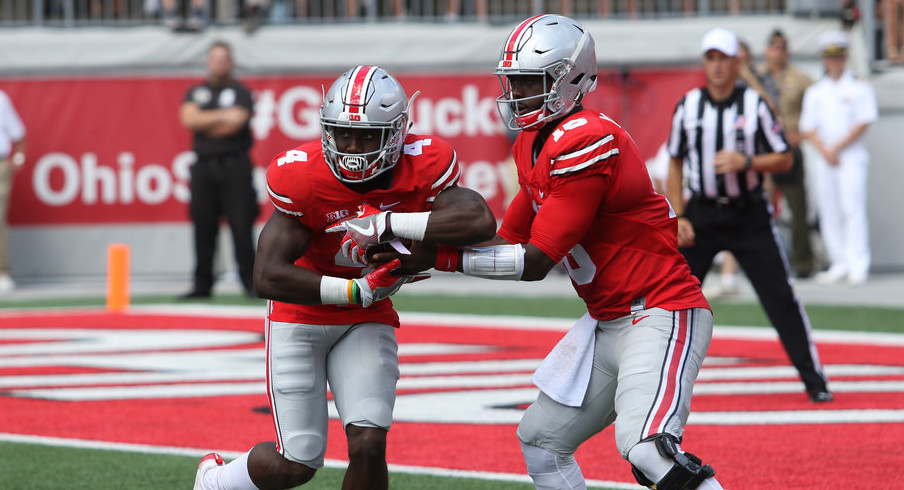 J.T. Barrett hands off to Curtis Sameul. J.T. Barrett hands off to Curtis Sameul.