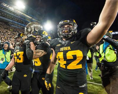 	Nov 14, 2015; Iowa City, IA, USA; The Iowa Hawkeyes grasp the Floyd of Rosedale trophy after the game against the Minnesota Golden Gophers at Kinnick Stadium. Iowa won 40-35. Mandatory Credit: Jeffrey Becker-USA TODAY Sports