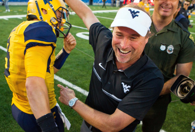 Oct 1, 2016; Morgantown, WV, USA; West Virginia Mountaineers head coach Dana Holgorsen celebrates with West Virginia Mountaineers quarterback Skyler Howard (3) after beating the Kansas State Wildcats at Milan Puskar Stadium. Mandatory Credit: Ben Queen-USA TODAY Sports