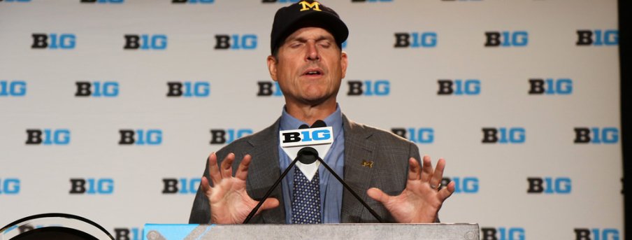 Harbaugh squeezing an imaginary butt.