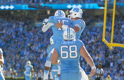 Nov 5, 2016; Chapel Hill, NC, USA; North Carolina Tar Heels quarterback Mitch Trubisky (10) celebrates his fourth quarter touchdown with wide receiver Jordan Cunningham (15) against the Georgia Tech Yellow Jackets at Kenan Memorial Stadium. The North Carolina Tar Heels defeated the Georgia Tech Yellow Jackets 48-20. Mandatory Credit: James Guillory-USA TODAY Sports