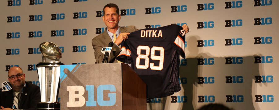 Crazy man holds up another crazy man's jersey.