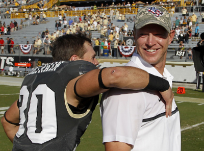 Nov 12, 2016; Orlando, FL, USA; UCF Knights head coach Scott Frost gets a hug from UCF Knights wide receiver Kyle Coltrain (30) after a football game against the Cincinnati Bearcats at Bright House Networks Stadium. UCF won 24-3 and with the win become bowl eligible. Mandatory Credit: Reinhold Matay-USA TODAY Sports