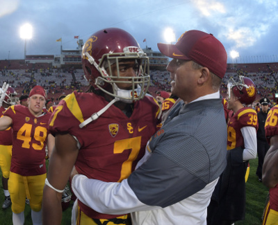 Nov 26, 2016; Los Angeles, CA, USA; Southern California Trojans head coach Clay Helton (left) and Southern California Trojans defensive back Marvell Tell III (7) embrace during a NCAA football game against the Notre Dame Fighting Irish at Los Angeles Memorial Coliseum. USC defeated Notre Dame 45-27. Mandatory Credit: Kirby Lee-USA TODAY Sports