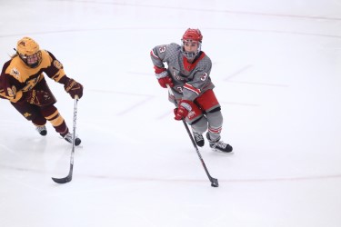 Jincy Dunne carries the puck against the Gophers. (Courtesy of OSU Athletics)