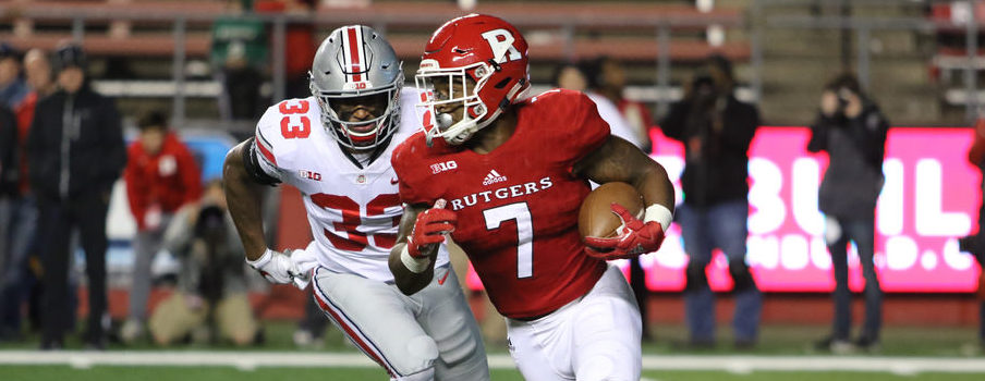 Dante Booker chases down Rutgers running back Robert Martin during Saturday night's game.