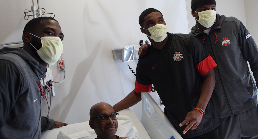 J.T. Barrett, Jeffrey Okudah and Jaylen Harris visit with James Williams.