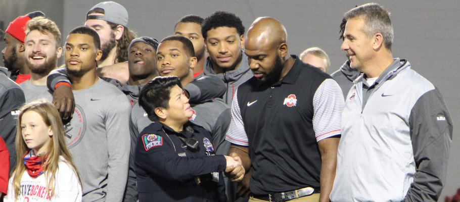 Urban Meyer and Ryan Stamper chat with an Ohio State Police officer before taking a group photo at Wednesday's event.