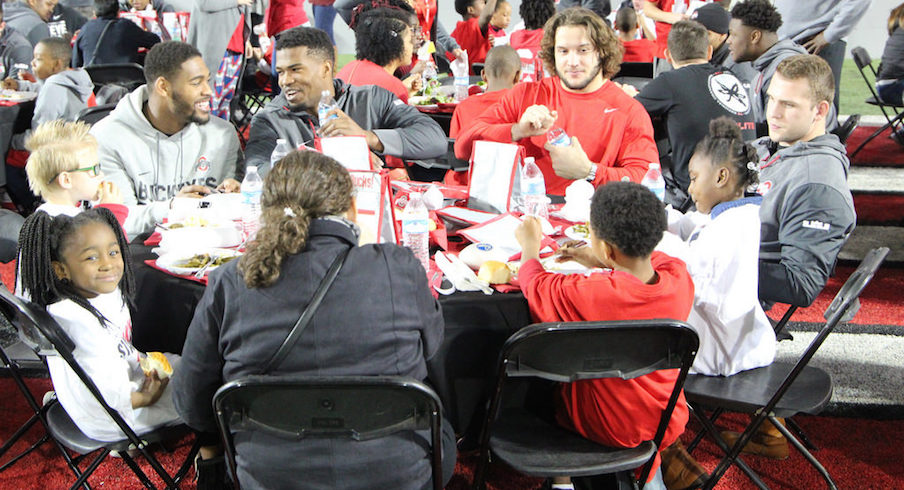 Jonathon Cooper, Nick Bosa and other members of the Ohio State football team eat lunch with local schoolchildren.