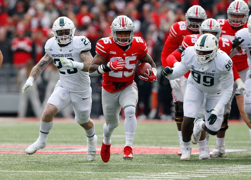 Nov 11, 2017; Columbus, OH, USA; Ohio State Buckeyes running back Mike Weber (25) breaks away from Michigan State Spartans linebacker Chris Frey (23) and Michigan State Spartans defensive tackle Raequan Williams (99) for a touchdown during the first quarter at Ohio Stadium. Mandatory Credit: Joe Maiorana-USA TODAY Sports