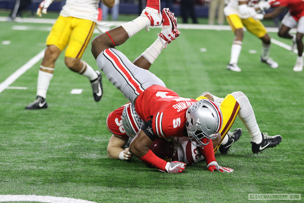 Baron Browning assists on a tackle in the Cotton Bowl