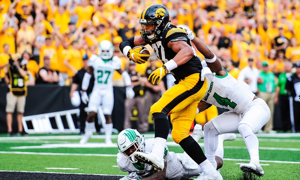 Sep 16, 2017; Iowa City, IA, USA; Iowa Hawkeyes tight end Noah Fant (87) scores a touchdown as North Texas Mean Green safety Keshawn McClain (6) and safety Khairi Muhammad (4) attempt to tackle during the third quarter at Kinnick Stadium. Mandatory Credit: Jeffrey Becker-USA TODAY Sports