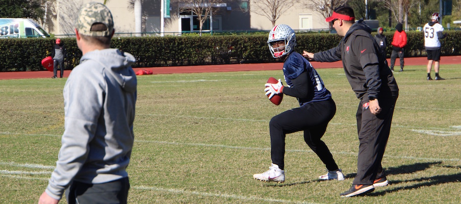 J.T. Barrett avoids a tag from Zack Grossi during a drill at East-West Shrine Game practice.