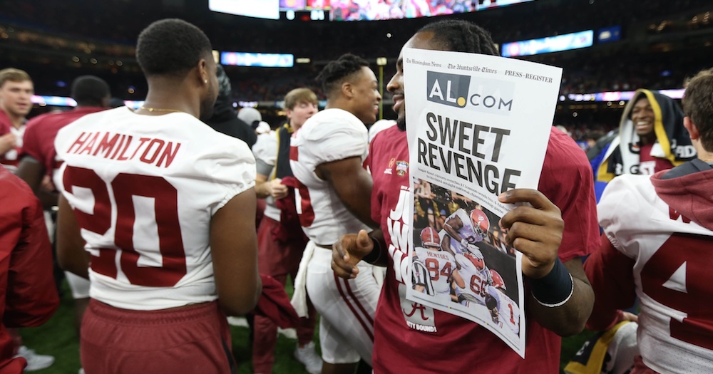 Jan 1, 2018; New Orleans, LA, USA; A newspaper cover in honor of the Alabama Crimson Tide win is held up after the game between the Alabama Crimson Tide and the Clemson Tigers in the 2018 Sugar Bowl college football playoff semifinal game at Mercedes-Benz Superdome. Mandatory Credit: Chuck Cook-USA TODAY Sports
