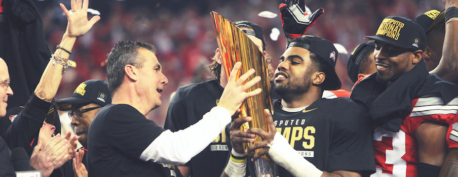 Ezekiel Elliott hold the trophy.