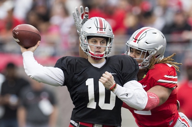 Apr 14, 2018; Columbus, OH, USA;Gray Team quarterback Joe Burrow (10) sends a pass upfield under pressure from Scarlet Team defensive end Chase Young (2) during the Spring Game at Ohio Stadium. Mandatory Credit: Greg Bartram-USA TODAY Sports