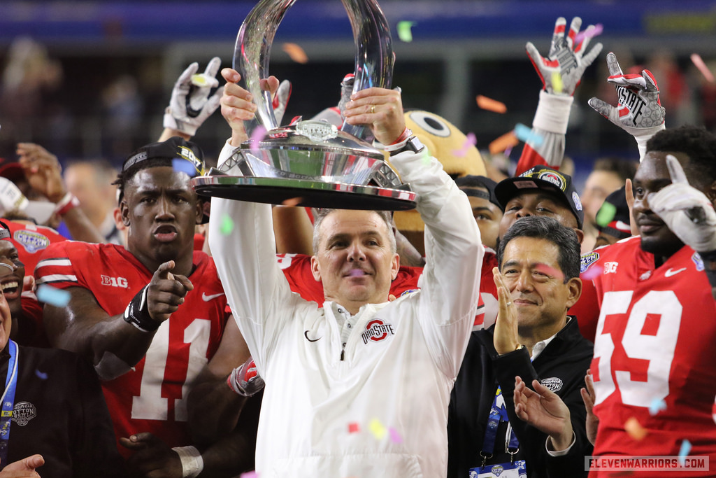 Ohio State head coach Urban Meyer raising the Big Ten Championship Trophy