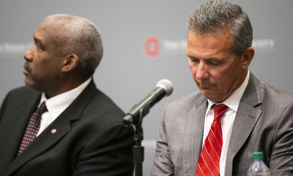 Aug 22, 2018; Columbus, OH, USA; Ohio State Buckeyes head coach Urban Meyer (right) listens as university president Michael Drake speaks at Longaberger Alumni House on the Ohio State University campus. Mandatory Credit: Greg Bartram-USA TODAY Sports