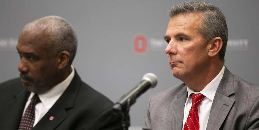 Aug 22, 2018; Columbus, OH, USA; Ohio State Buckeyes head coach Urban Meyer (right) and athletic director Gene Smith (left) listen as university president Michael Drake addresses the media at Longaberger Alumni House on the Ohio State University campus.. Mandatory Credit: Greg Bartram-USA TODAY Sports