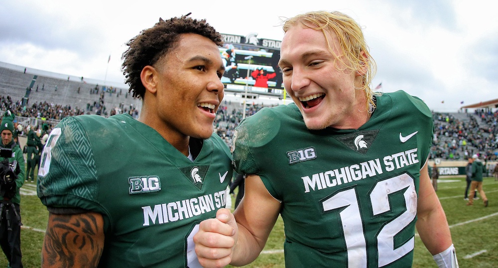 Oct 27, 2018; East Lansing, MI, USA; Michigan State Spartans quarterback Rocky Lombardi (12) and Michigan State Spartans wide receiver Jalen Nailor (8) celebrate a victory over the Purdue Boilermakers after a game at Spartan Stadium. Mandatory Credit: Mike Carter-USA TODAY Sports