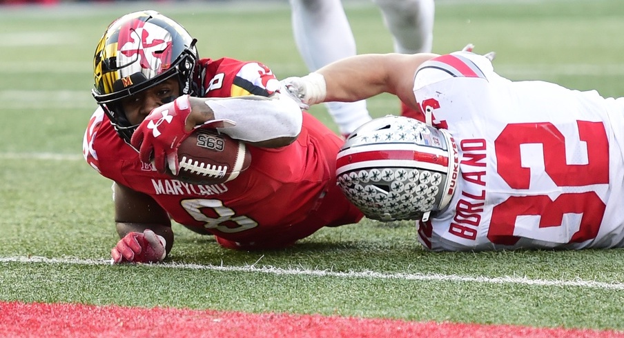 Nov 17, 2018; College Park, MD, USA; Maryland Terrapins Tayon Fleet-Davis (8) dives past Ohio State Buckeyes linebacker Tuf Borland (32) for a touchdown in overtime at Capital One Field at Maryland Stadium. Mandatory Credit: Tommy Gilligan-USA TODAY Sports