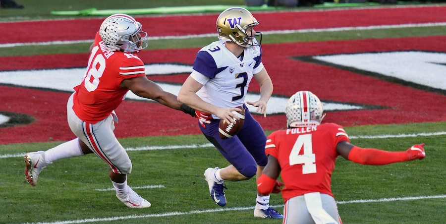 Jan 1, 2019; Pasadena, CA, USA; Washington Huskies quarterback Jake Browning (3) throws against Ohio State Buckeyes defensive end Jonathon Cooper (18) and safety Jordan Fuller (4) in the first half in the 2018 Rose Bowl at Rose Bowl Stadium. Mandatory Credit: Robert Hanashiro-USA TODAY Sports